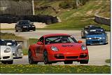  A rollcage-equipped Cayman leads a Boxster and massively-modified RX-7, M3, another 911, and Damian.