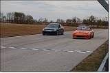  Rick and Damian pass a Valencia Orange Mazda RX-7.  It was just finished and being shaken down on the track.  Ask Rick about the gas...